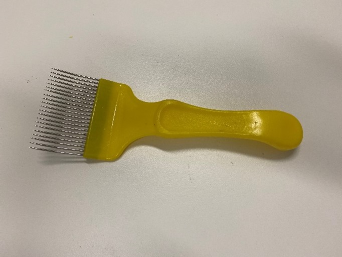 A comb scratcher with yellow plastic handle and steel fingers.