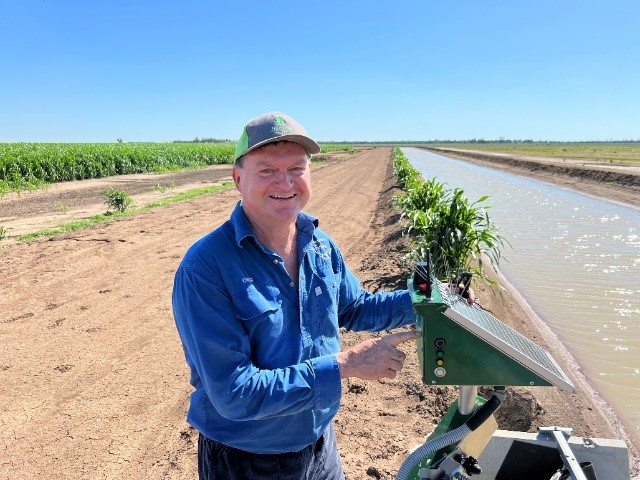 Farmer standing in front of water